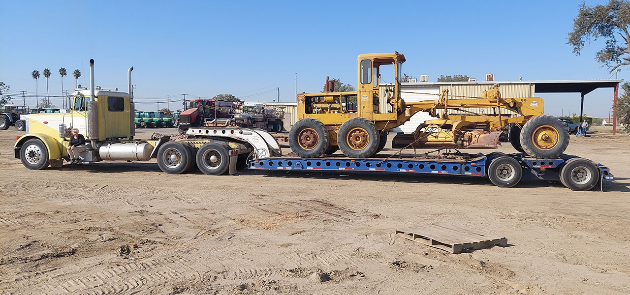 Caterpillar 12 Grader 99E with 1983 Peterbilt and 1980 Cozad